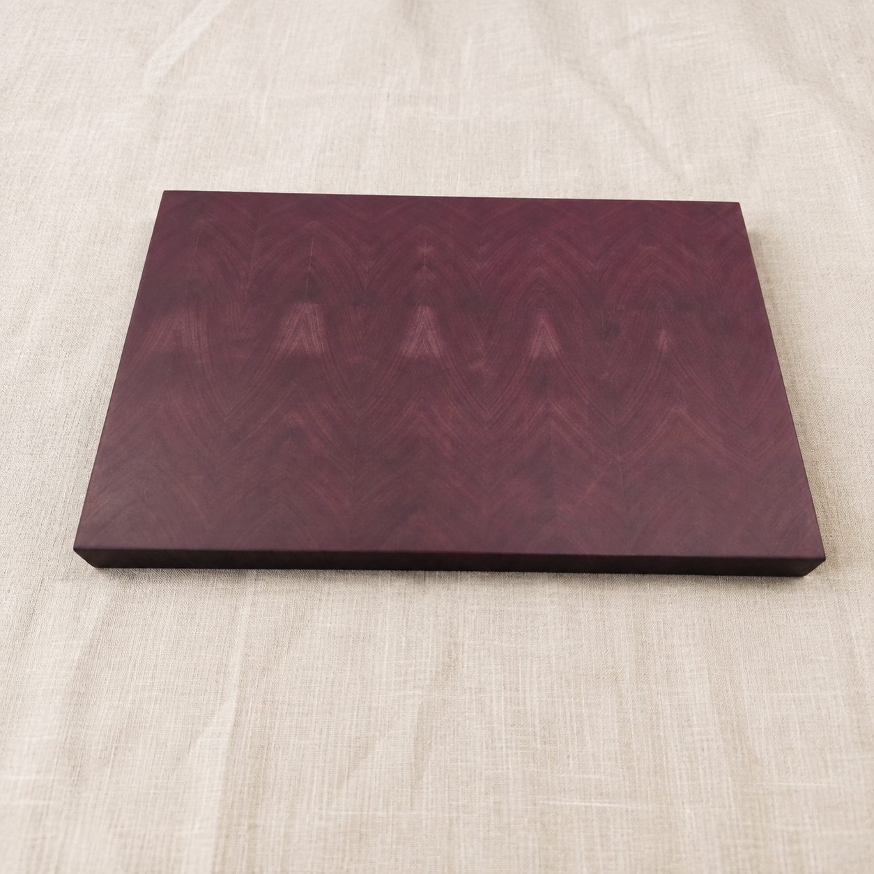 Custom purpleheart end grain cutting board with a chevron pattern