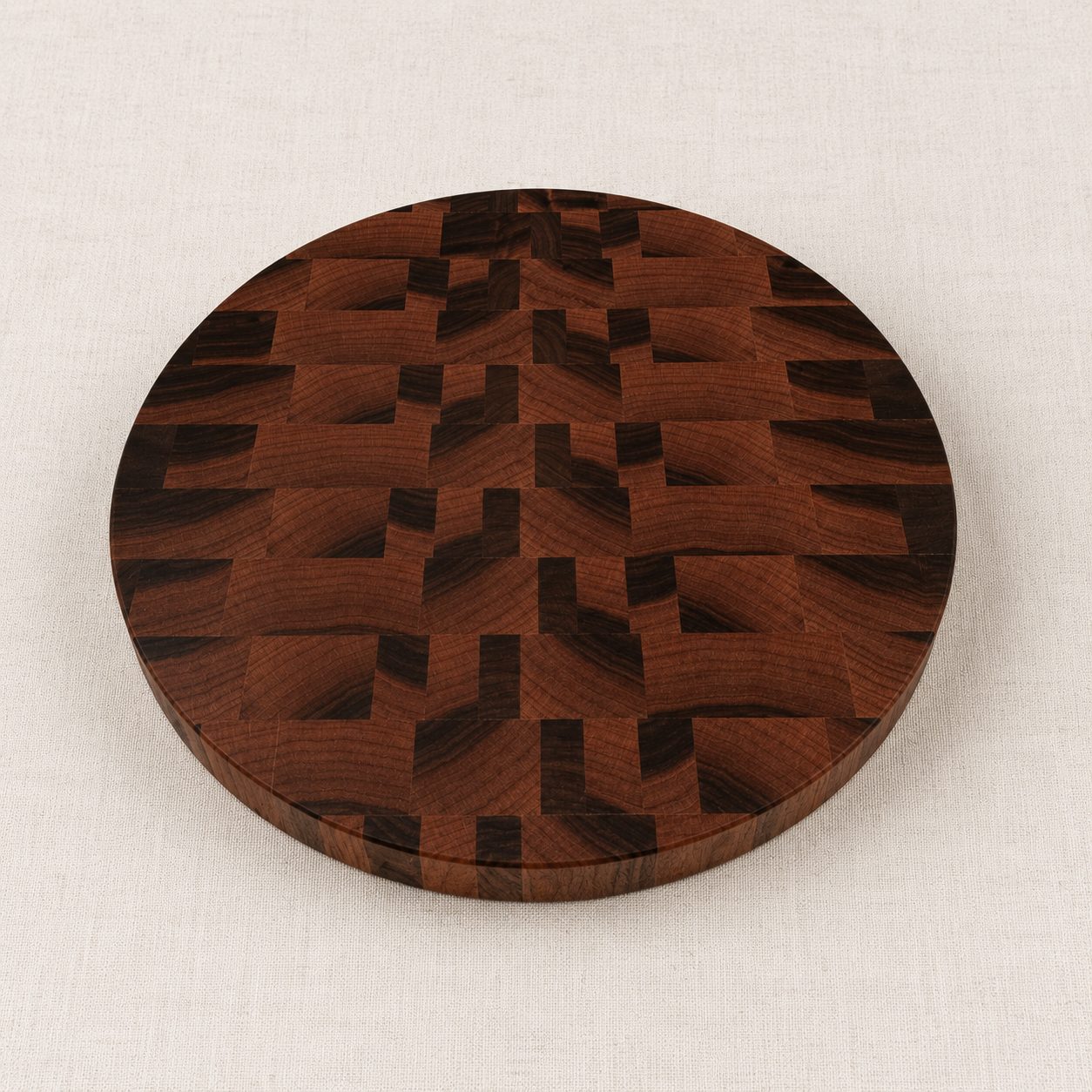 Round custom walnut end grain cutting board with a basket-weave pattern
